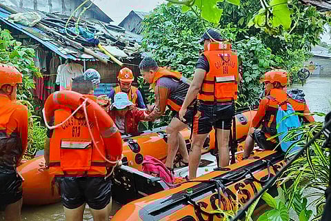 Philippines Tropical Storm Yagi: Rescuers use a rubber boat as they evacuate residents